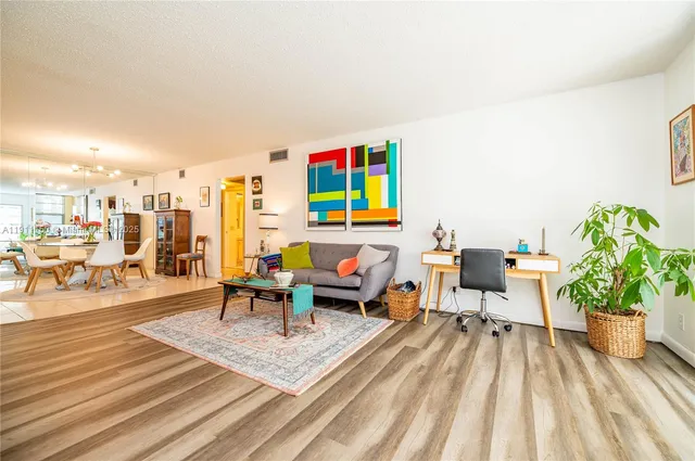 a living room with furniture and a potted plant