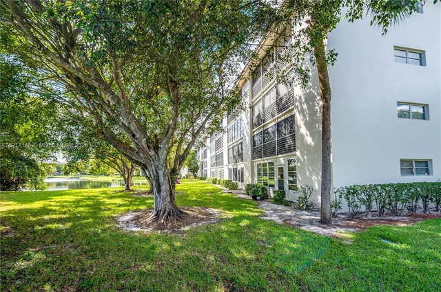 a view of a yard with large trees