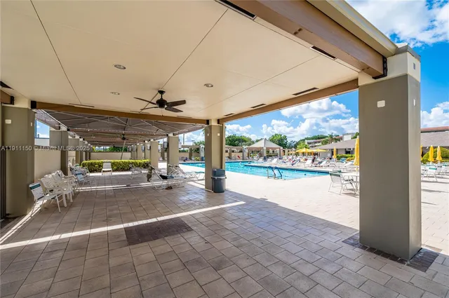 a view of a patio with dining table and chairs with a fire pit