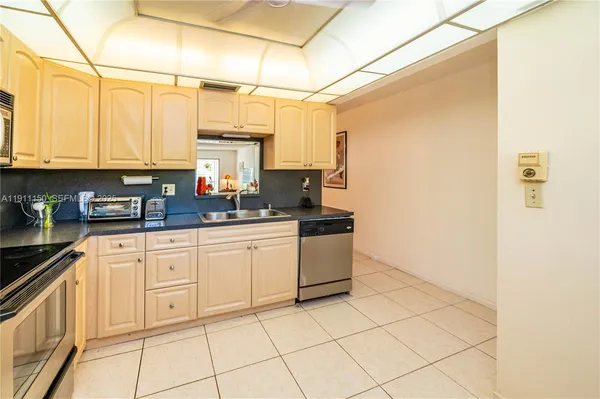 a kitchen with a white cabinets and white appliances