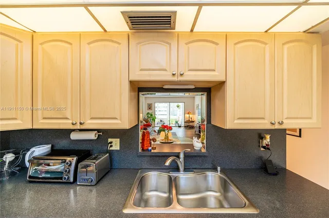 a kitchen that has a sink and a stove