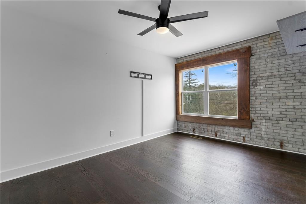 610 Madola Road, Unit 4 Epworth, GA 30541 - Photo 12 of 16 an empty room with wooden floor and windows