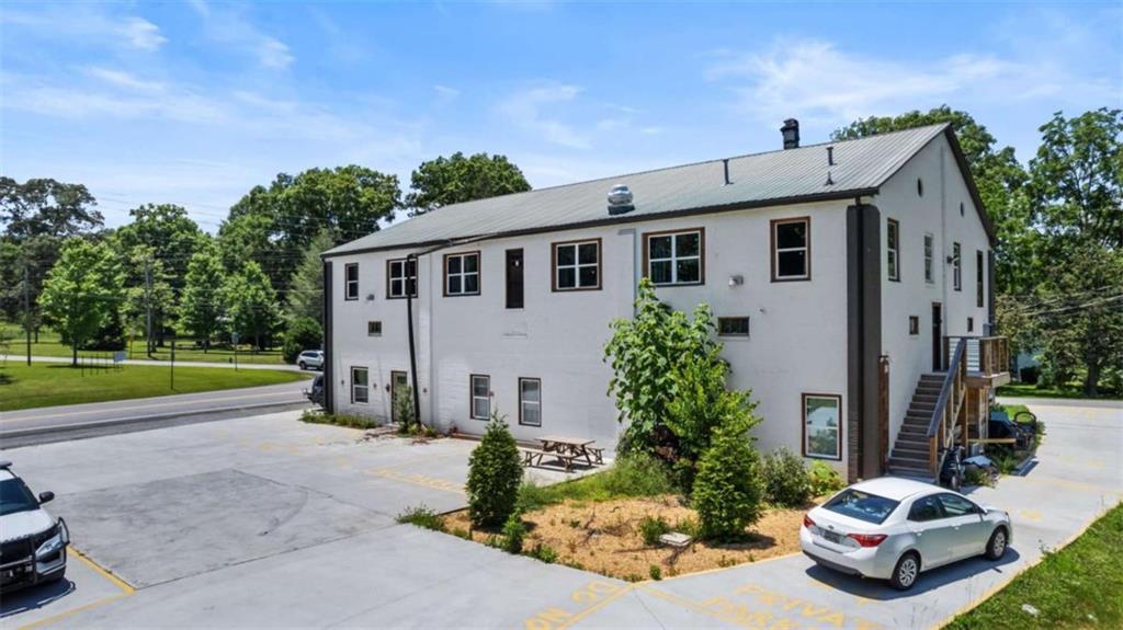 610 Madola Road, Unit 4 Epworth, GA 30541 - Photo 2 of 16 a car parked in front of house with a yard