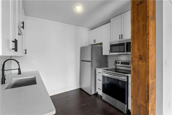 a kitchen with a refrigerator stove and sink