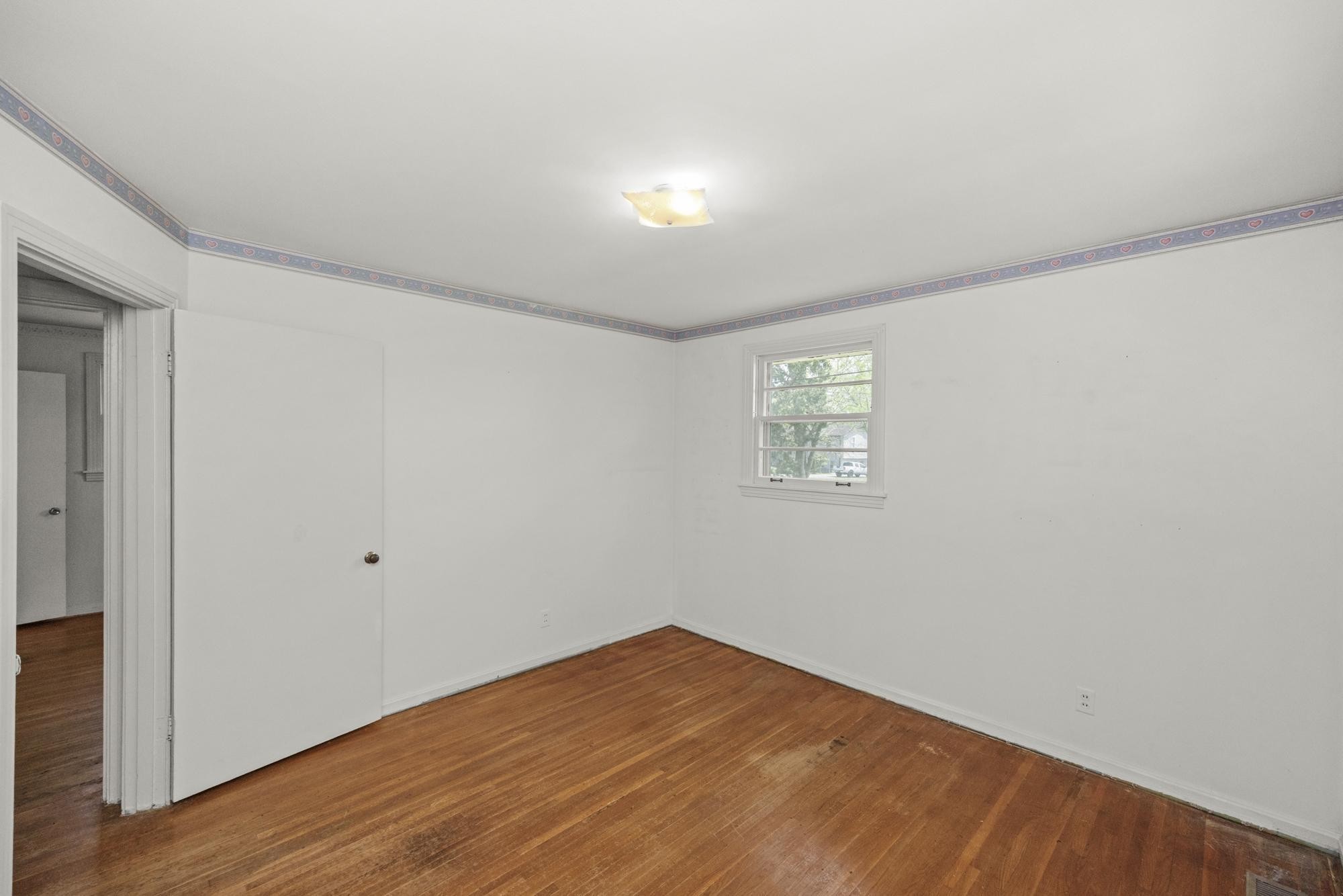 127 Riviera Drive Hendersonville, TN 37075 - Photo 28 of 46 a view of an empty room with wooden floor and a window