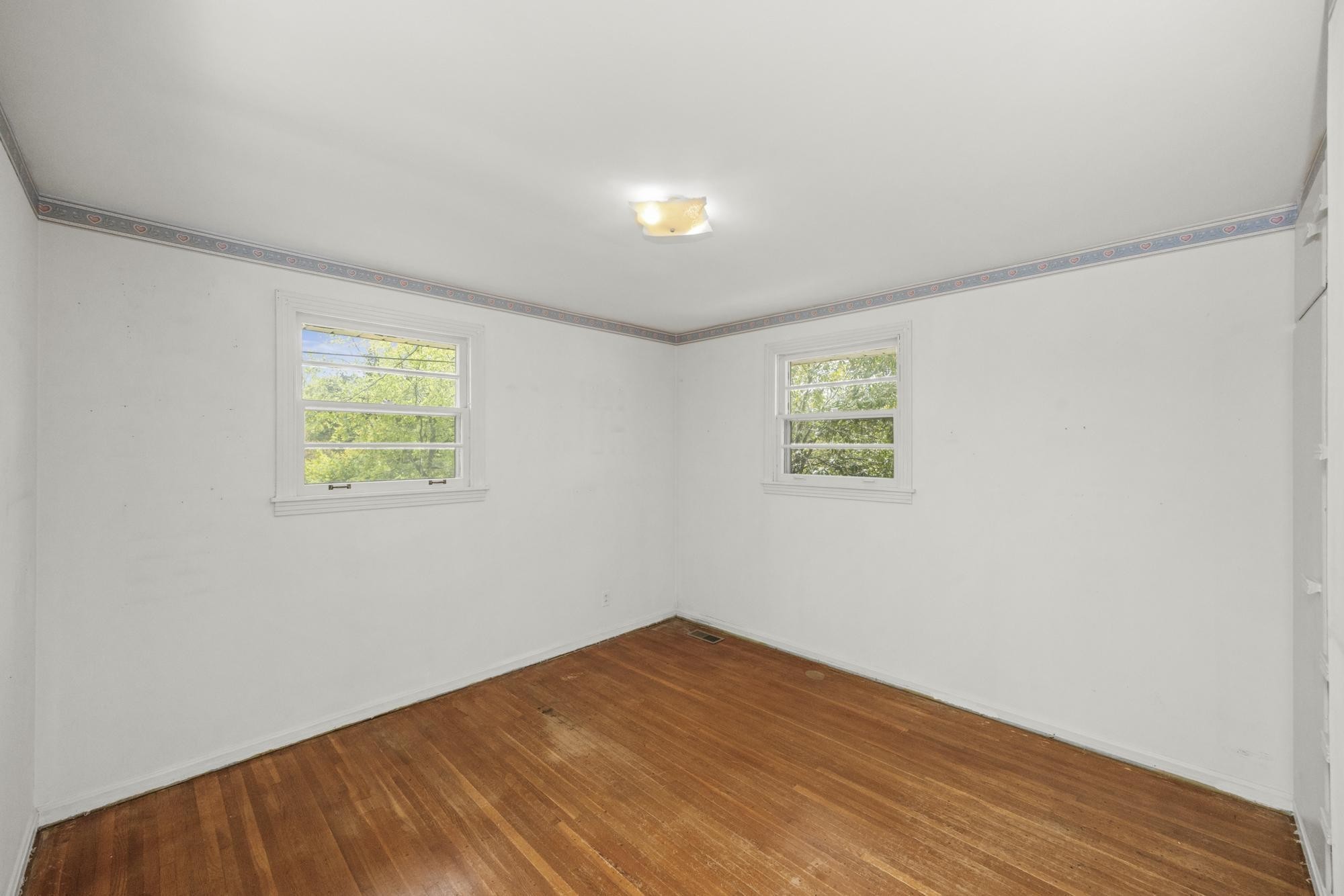 127 Riviera Drive Hendersonville, TN 37075 - Photo 31 of 46 an empty room with wooden floor and windows