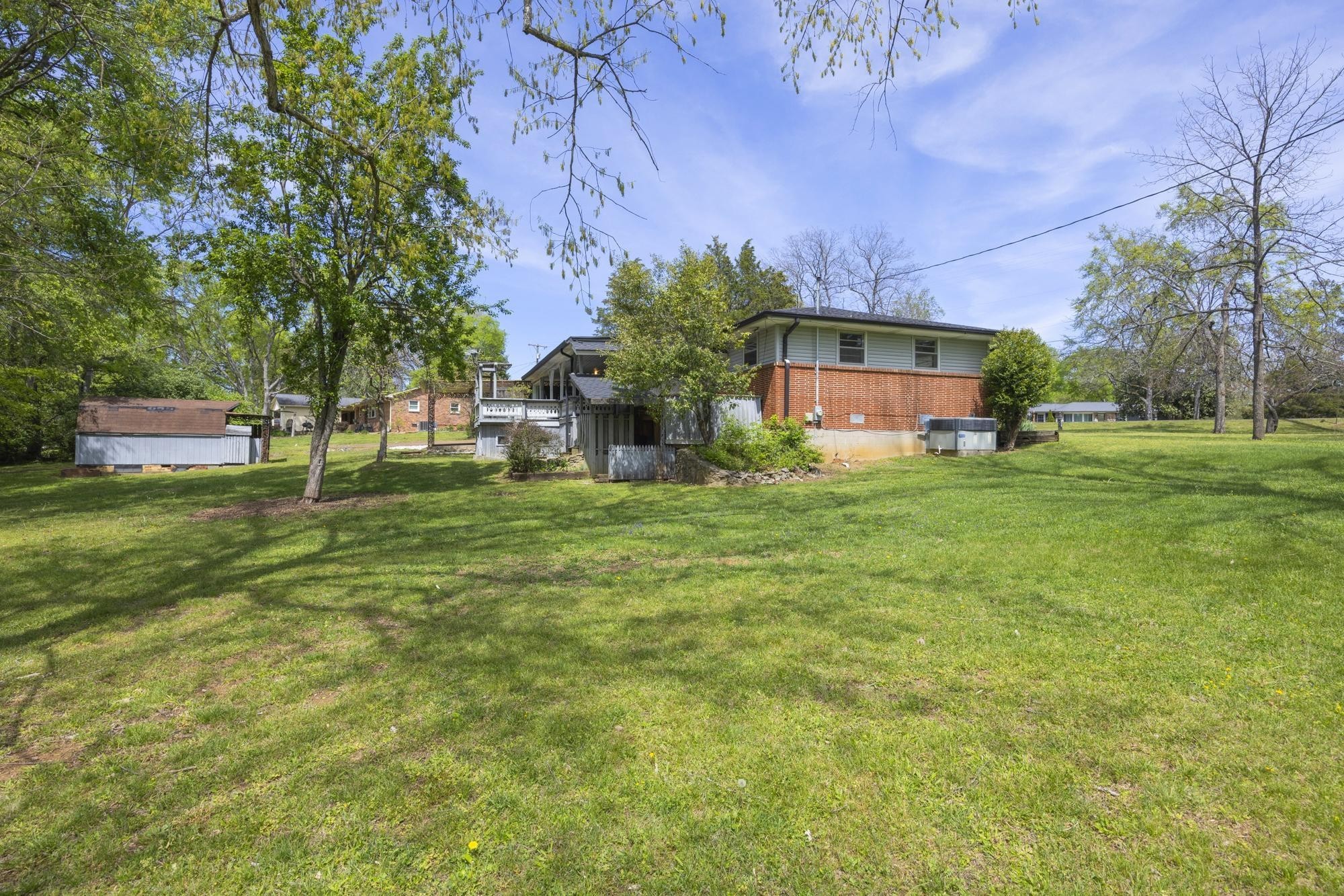 127 Riviera Drive Hendersonville, TN 37075 - Photo 6 of 46 a view of a house with a big yard and large trees
