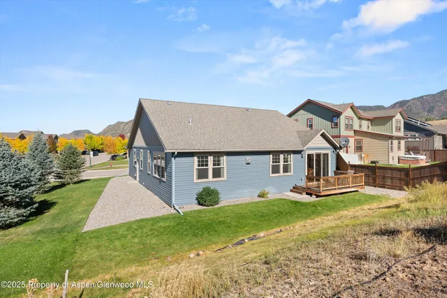 a view of a house with a yard and table