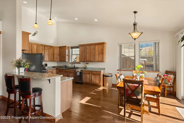 a large kitchen with a table and chairs