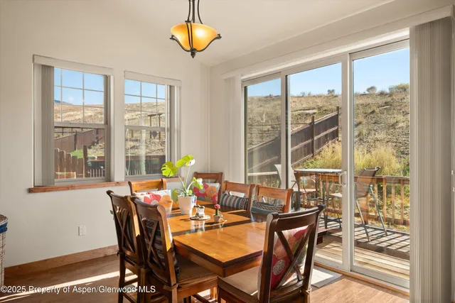 a dining room with furniture a chandelier and wooden floor