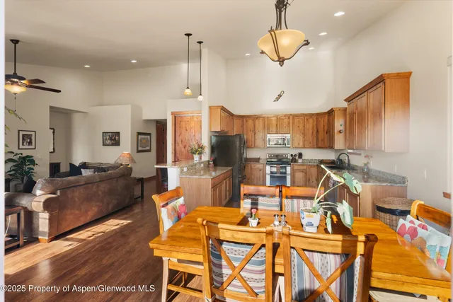 a large kitchen with a table and chairs