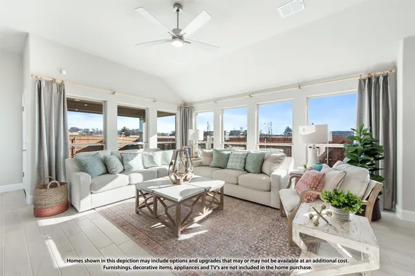 a living room with furniture wooden floor and a large window