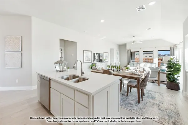 a kitchen with kitchen island a sink stove and refrigerator