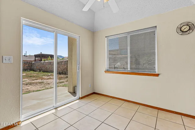 a kitchen with granite countertop cabinets stove top oven and microwave