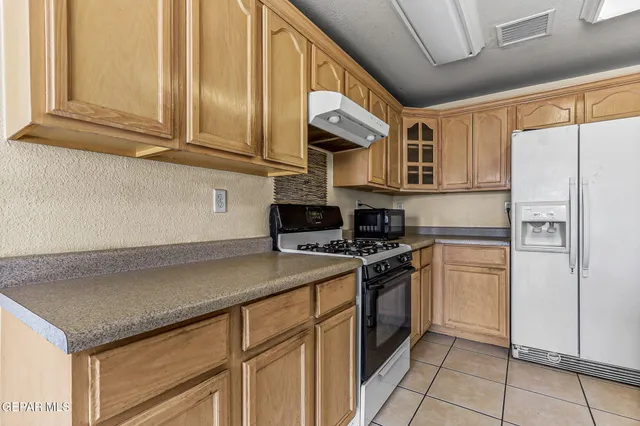 a kitchen with a sink and a refrigerator