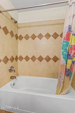 an empty room with chandelier fan