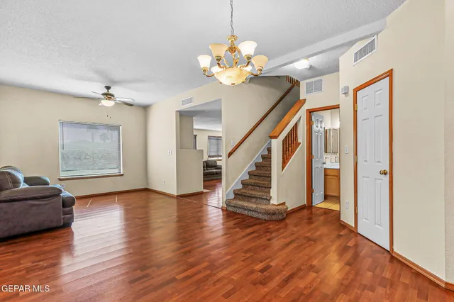 a view of an entryway with wooden floor and a chandelier