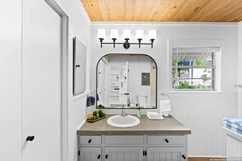a bathroom with a shower curtain and a sink