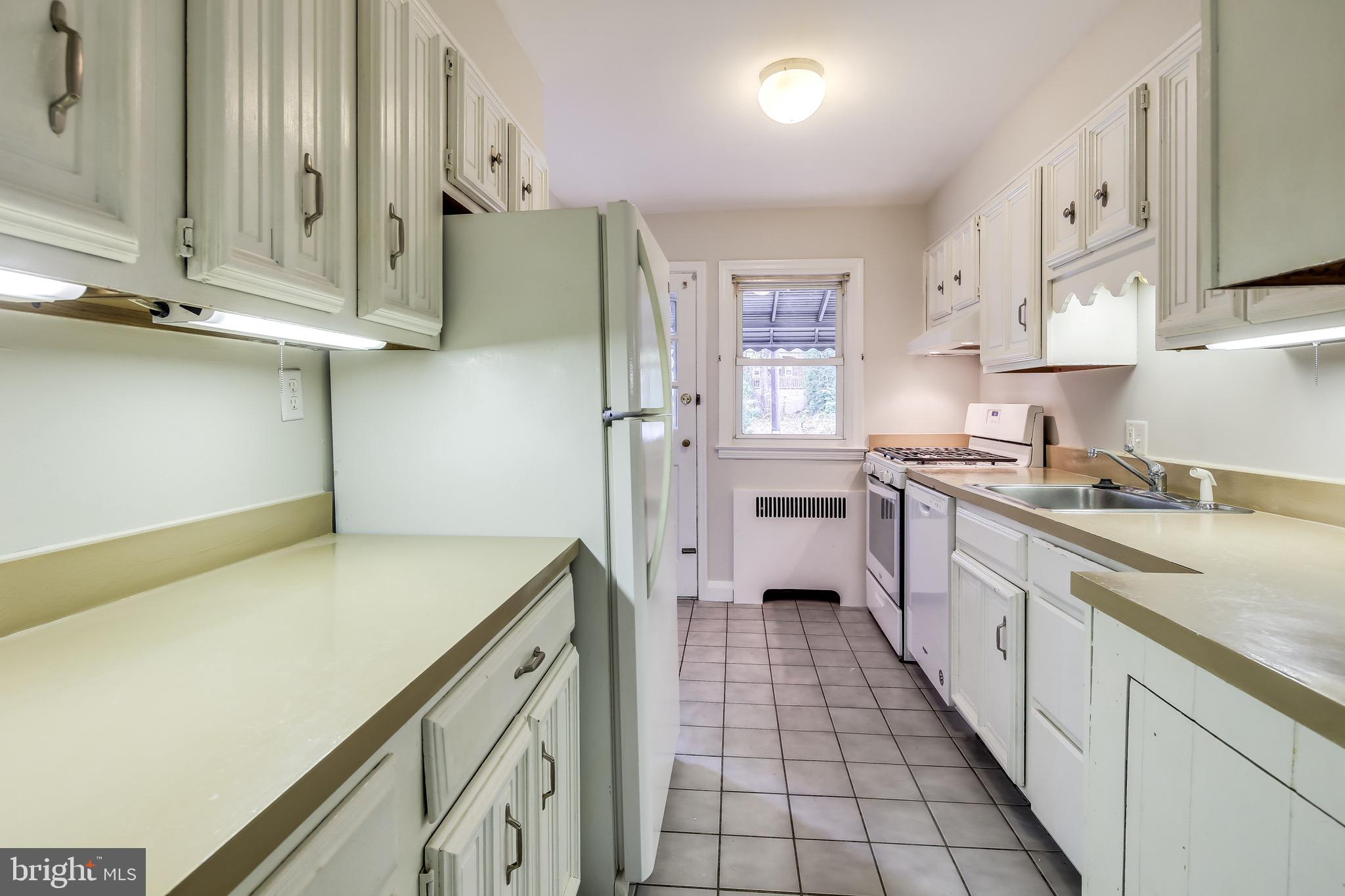 134 Cherrydell Road Baltimore, MD 21228 - Photo 13 of 36 a kitchen with stainless steel appliances a sink and cabinets