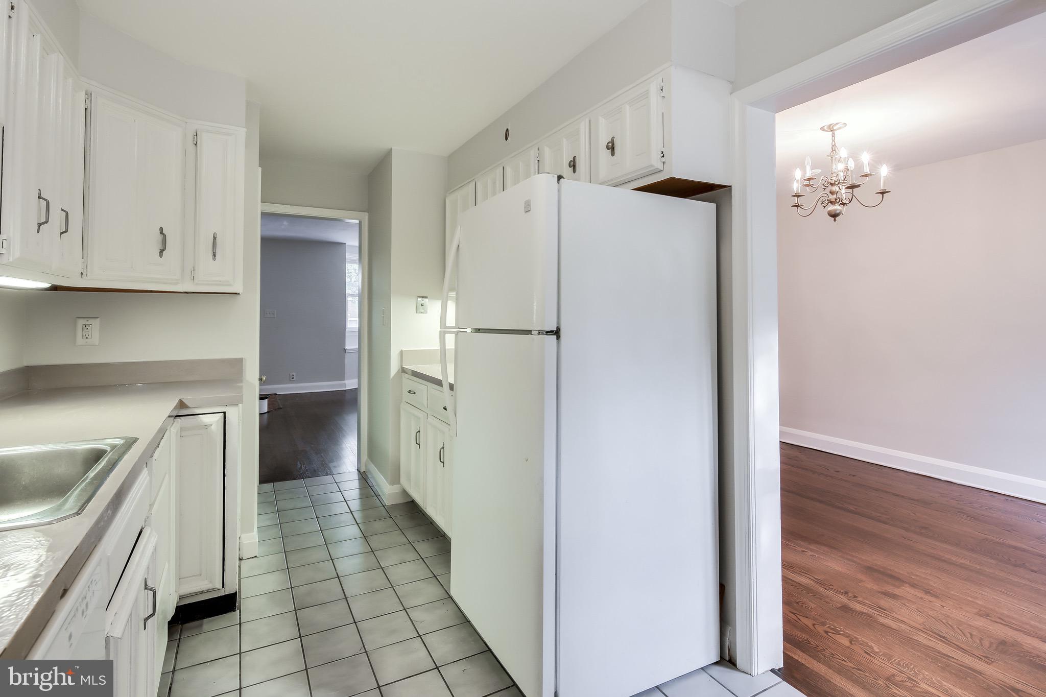 134 Cherrydell Road Baltimore, MD 21228 - Photo 14 of 36 a kitchen with white cabinets and white appliances