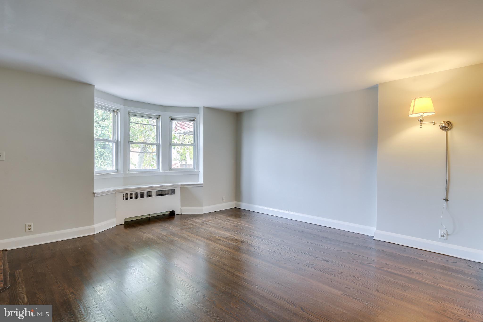 134 Cherrydell Road Baltimore, MD 21228 - Photo 15 of 36 an empty room with wooden floor and windows
