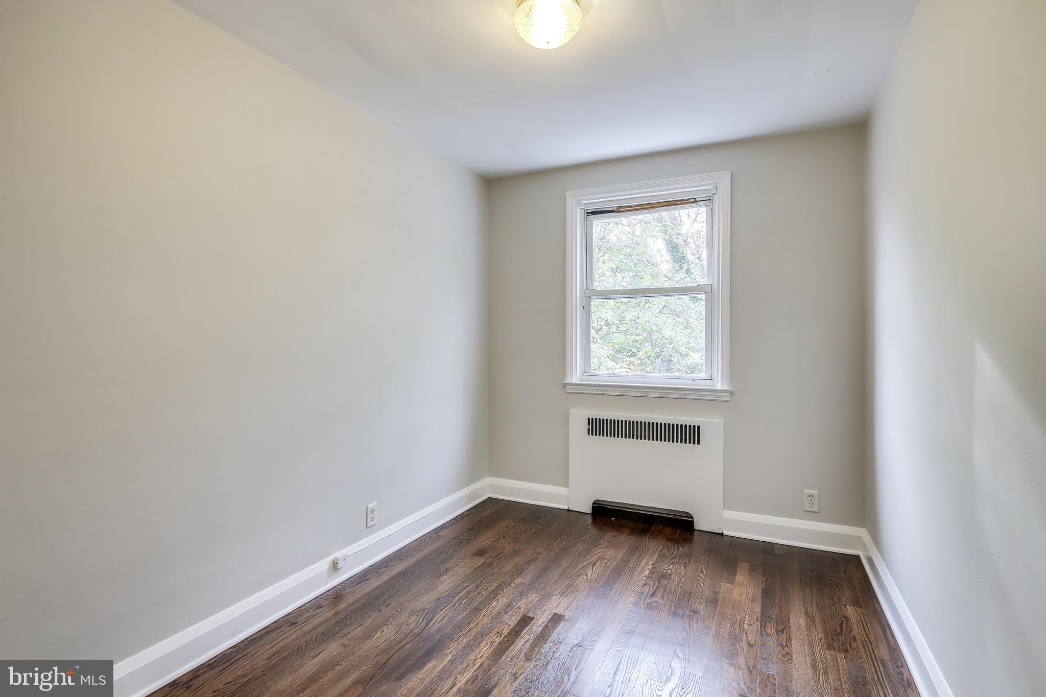 134 Cherrydell Road Baltimore, MD 21228 - Photo 20 of 36 an empty room with wooden floor and windows