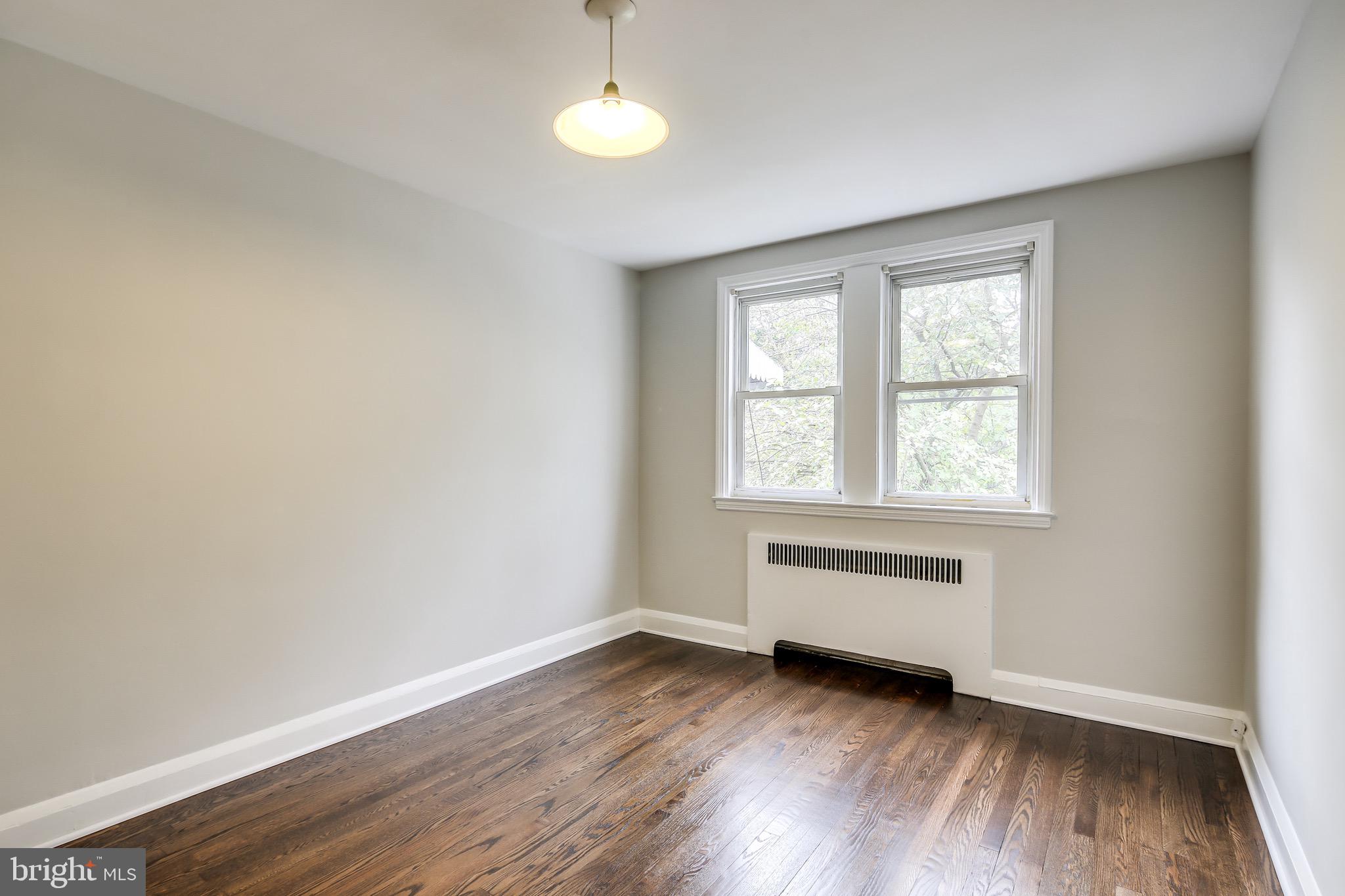 134 Cherrydell Road Baltimore, MD 21228 - Photo 23 of 36 an empty room with wooden floor and windows