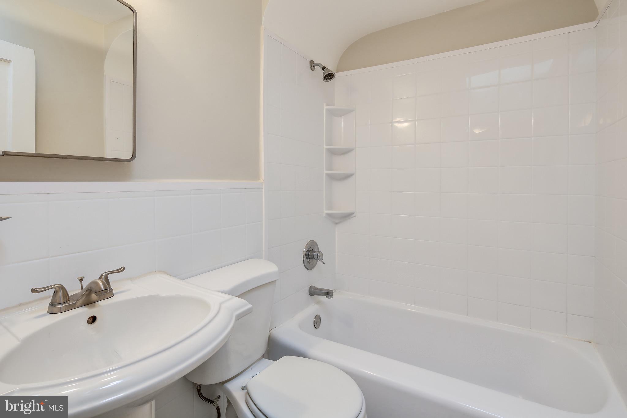 134 Cherrydell Road Baltimore, MD 21228 - Photo 25 of 36 a bathroom with a bathtub shower sink vanity and toilet