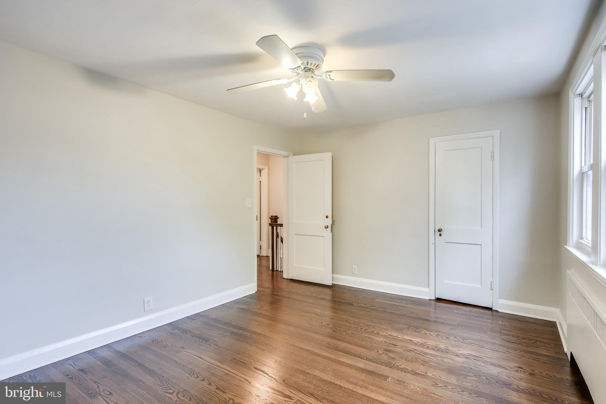 134 Cherrydell Road Baltimore, MD 21228 - Photo 29 of 36 an empty room with wooden floor and windows