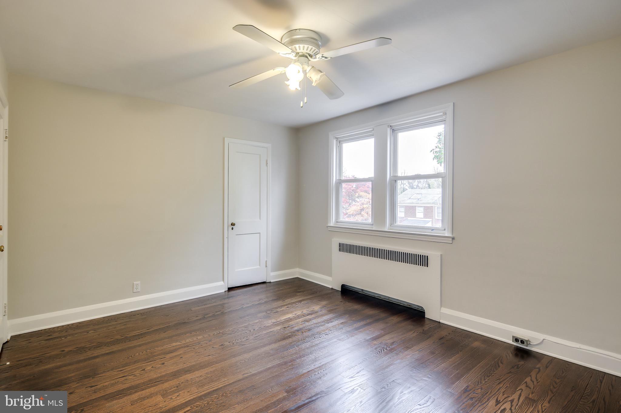 134 Cherrydell Road Baltimore, MD 21228 - Photo 30 of 36 an empty room with wooden floor and windows