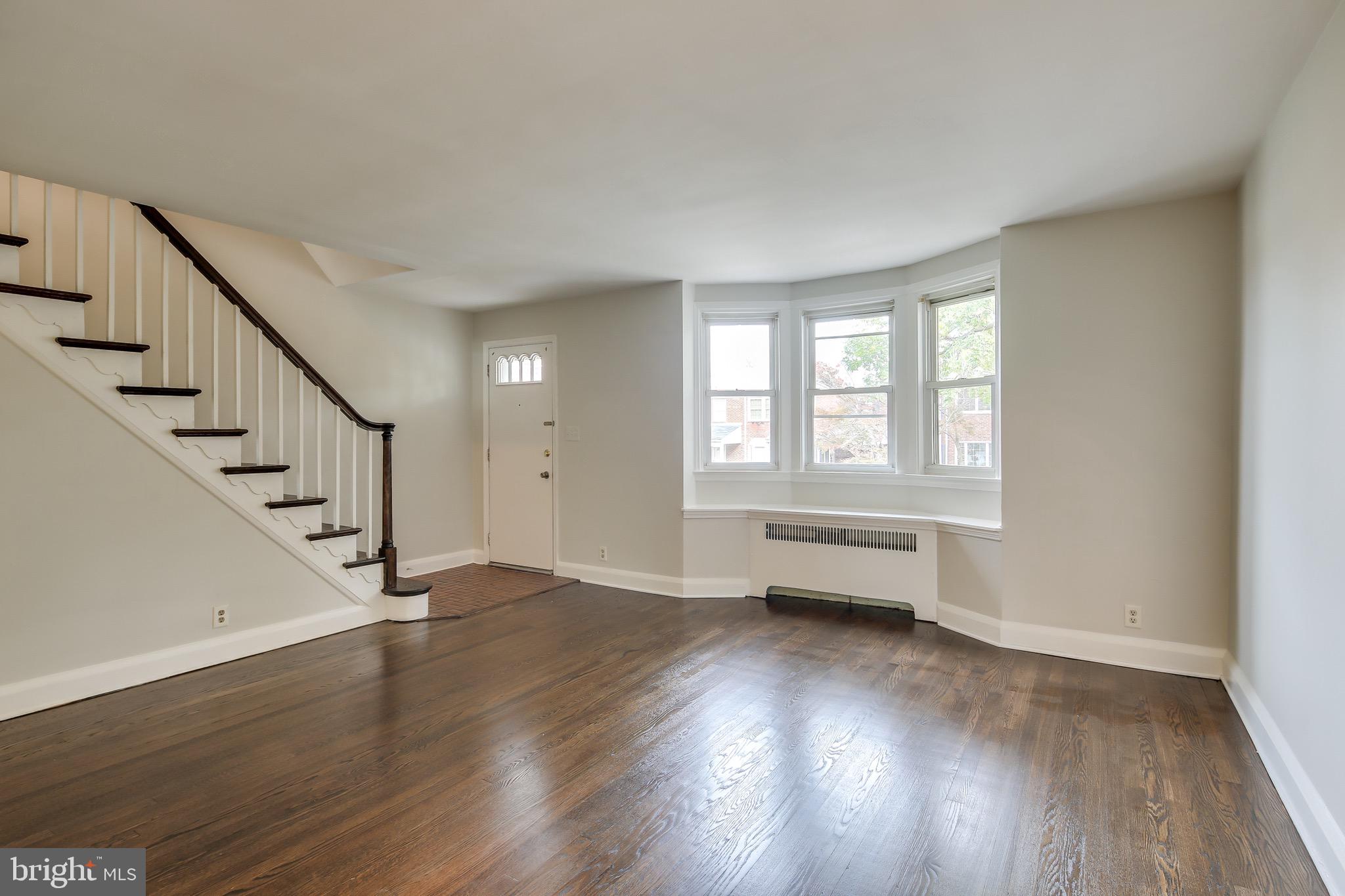 134 Cherrydell Road Baltimore, MD 21228 - Photo 9 of 36 a view of an empty room with wooden floor and a window