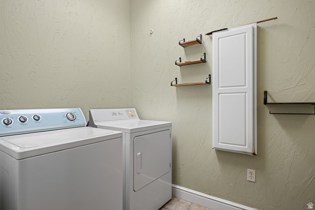 20 Valley Road Leeds, UT 84746 - Photo 16 of 57 Laundry area featuring textured walls, white baseboards, and wood-finish shelving