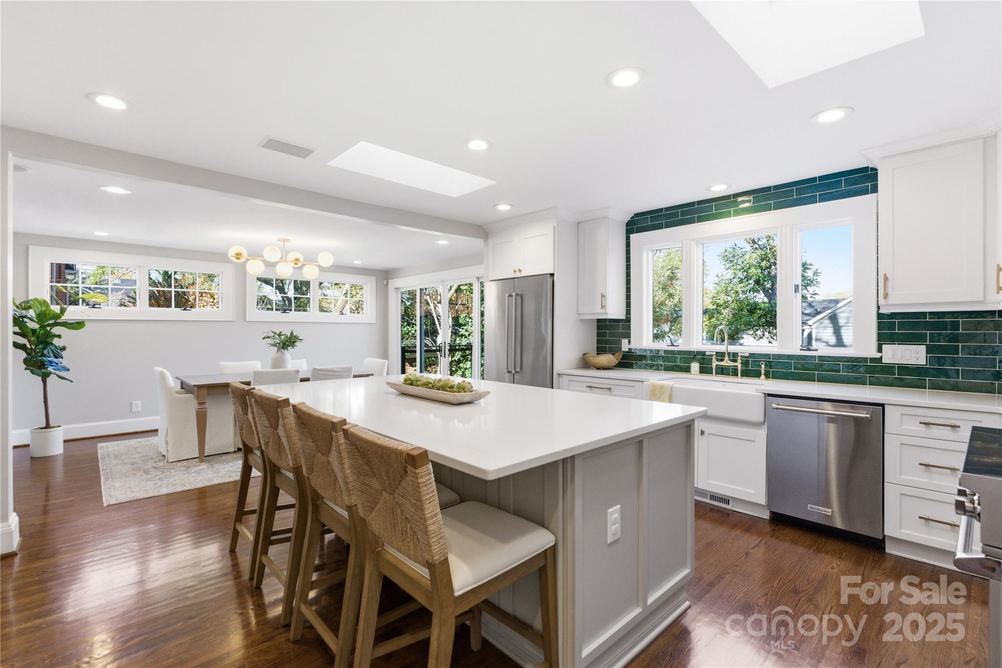 1305 Lilac Road Charlotte, NC 28209 - Photo 13 of 48 a kitchen with stainless steel appliances granite countertop table chairs sink and cabinets