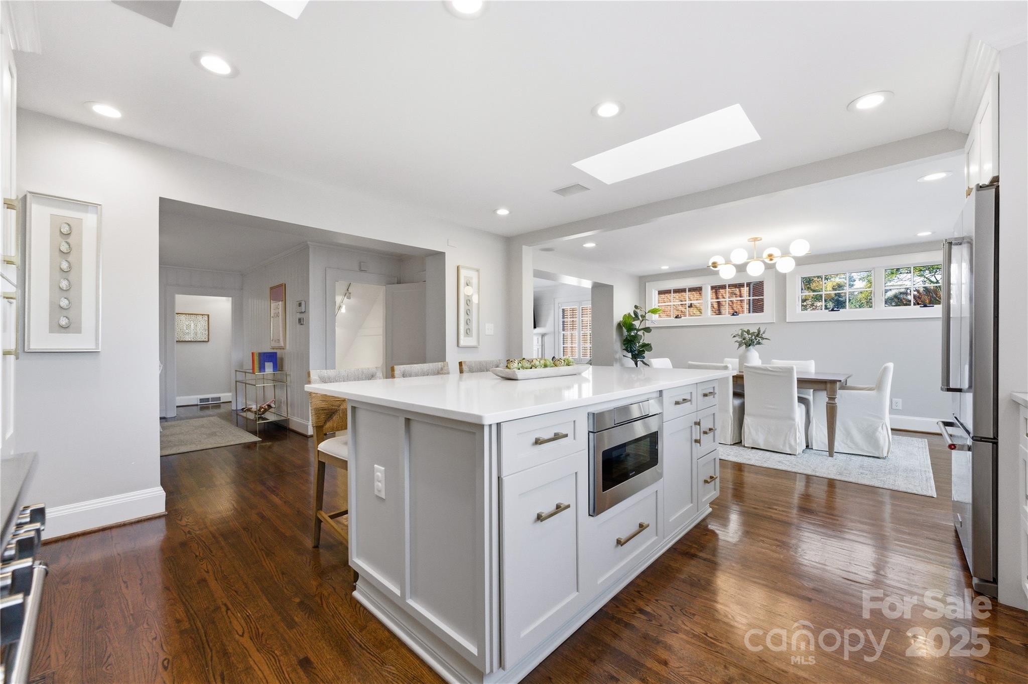 1305 Lilac Road Charlotte, NC 28209 - Photo 14 of 48 a large white kitchen with lots of counter space wooden floor and appliances