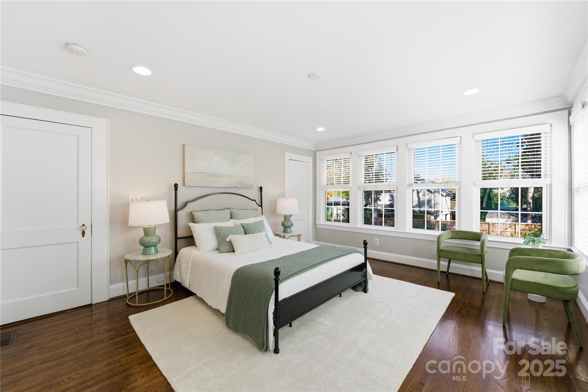 1305 Lilac Road Charlotte, NC 28209 - Photo 18 of 48 a spacious bedroom with a bed a couch and large window