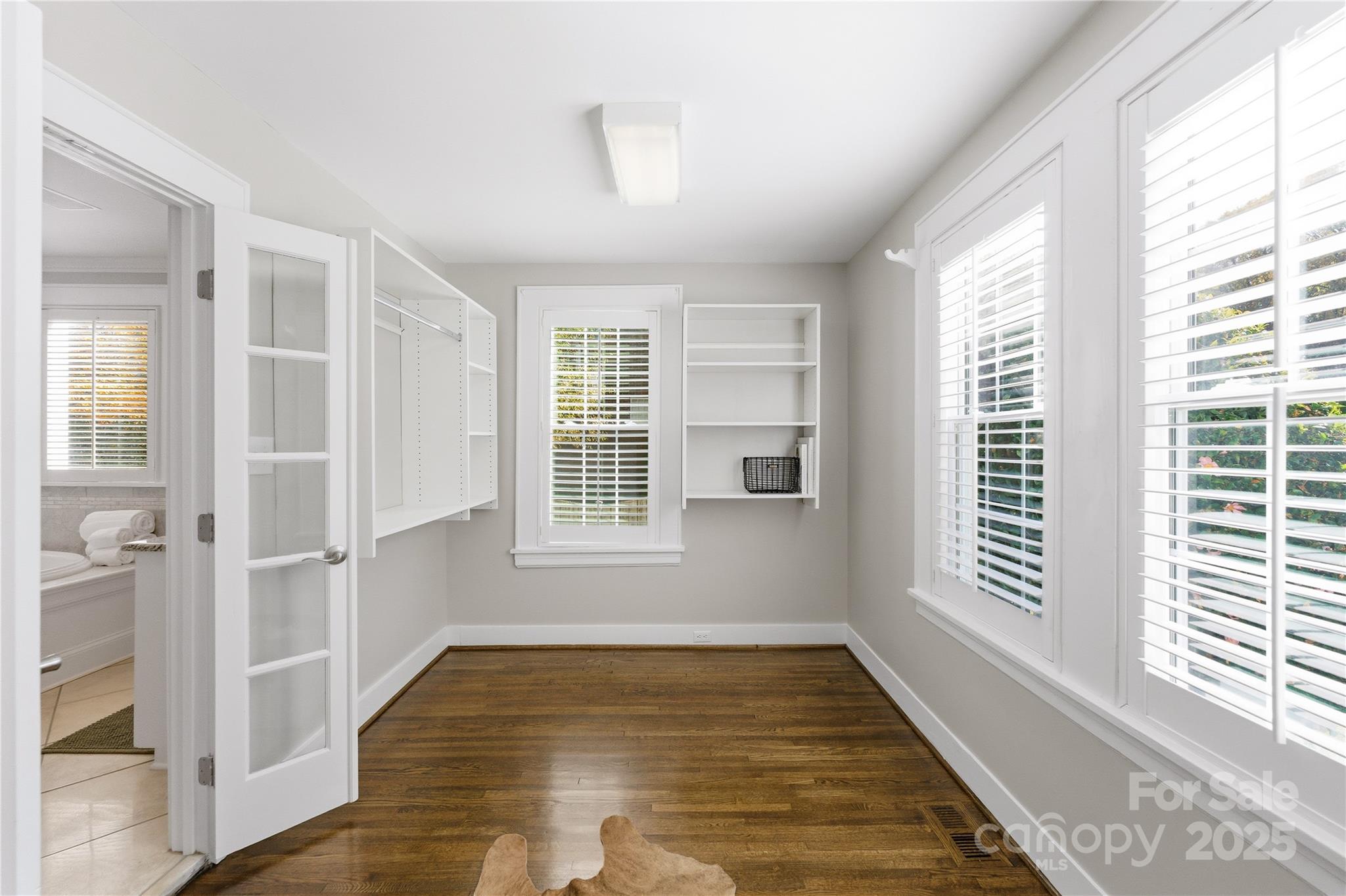 1305 Lilac Road Charlotte, NC 28209 - Photo 24 of 48 an empty room with wooden floor and windows