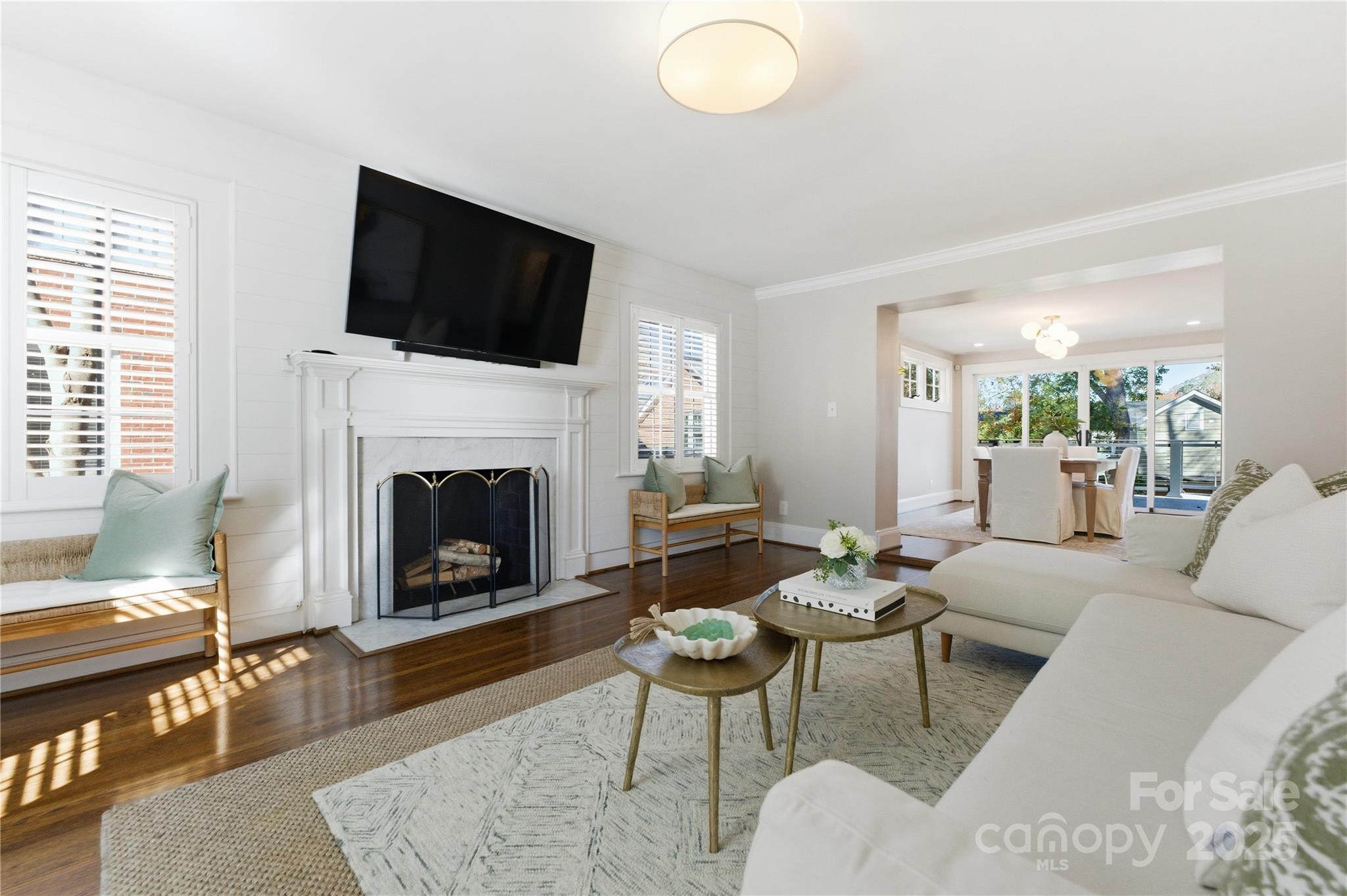 1305 Lilac Road Charlotte, NC 28209 - Photo 3 of 48 a living room with furniture a flat screen tv and a fireplace