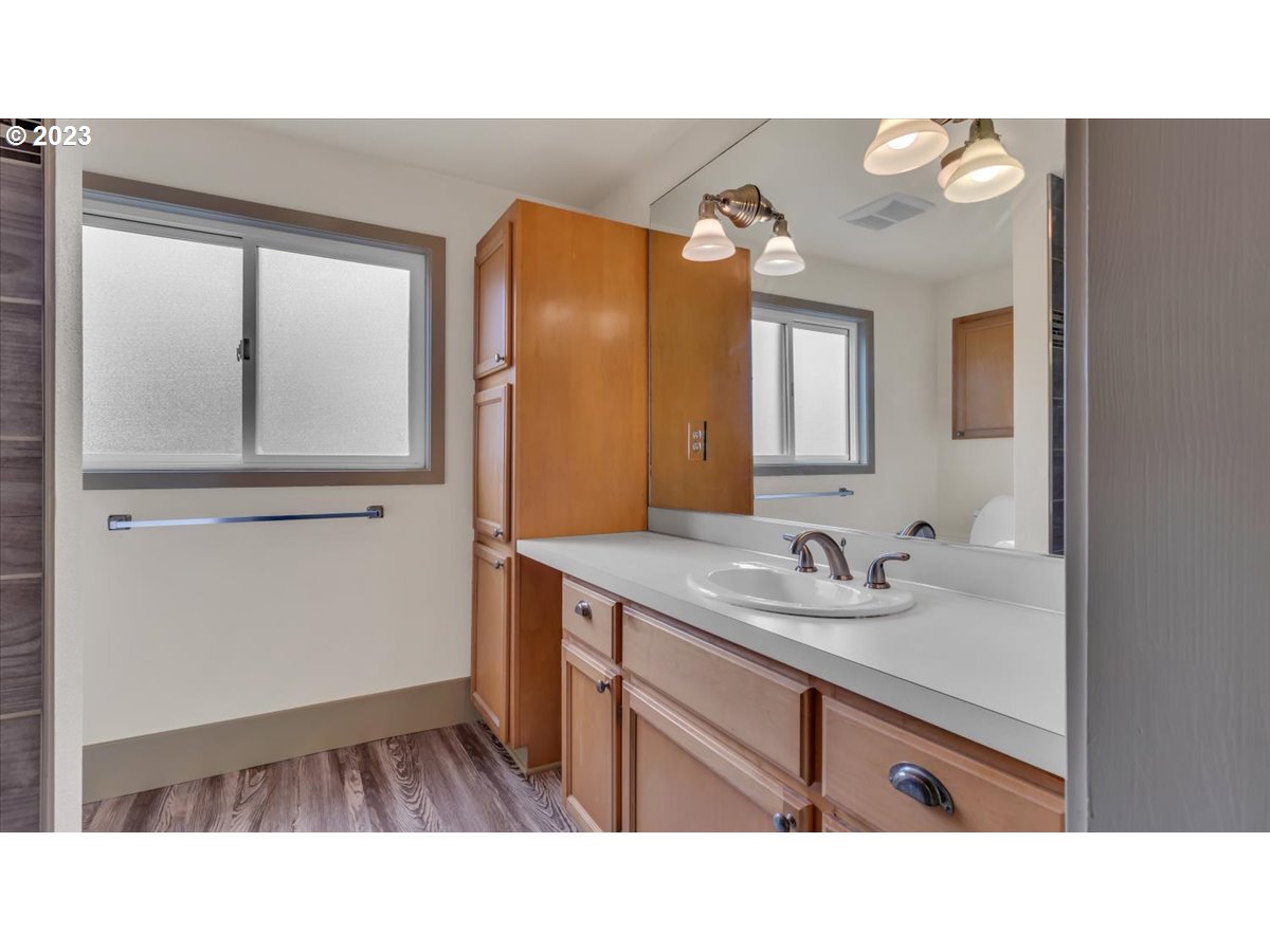 1318 15th Street Oregon City, OR 97045 - Photo 20 of 38 a bathroom with a sink a mirror and a shower