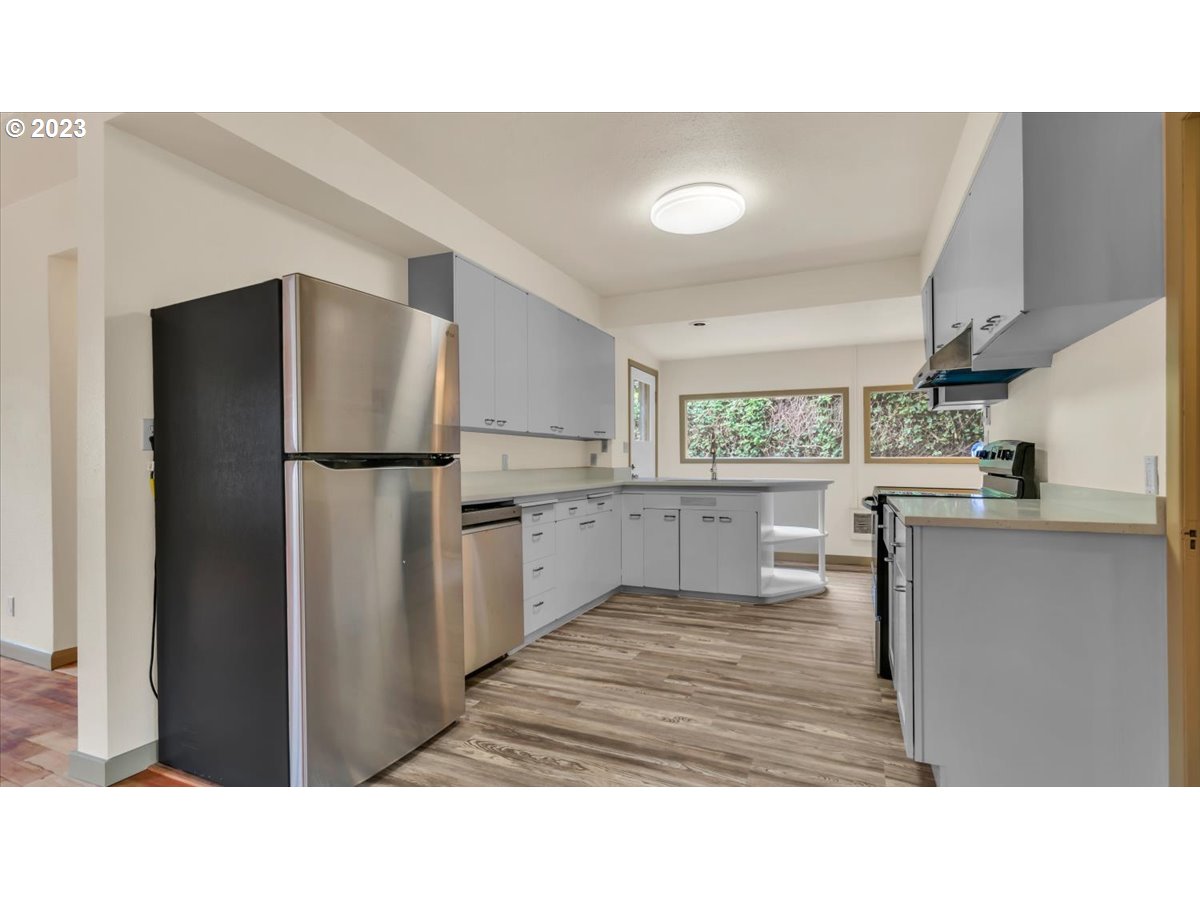 1318 15th Street Oregon City, OR 97045 - Photo 8 of 38 a kitchen with white cabinets and refrigerator