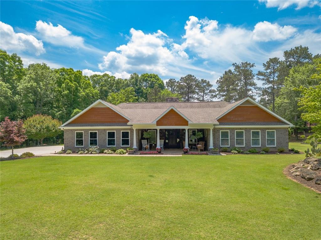 a white house with a big yard and palm trees