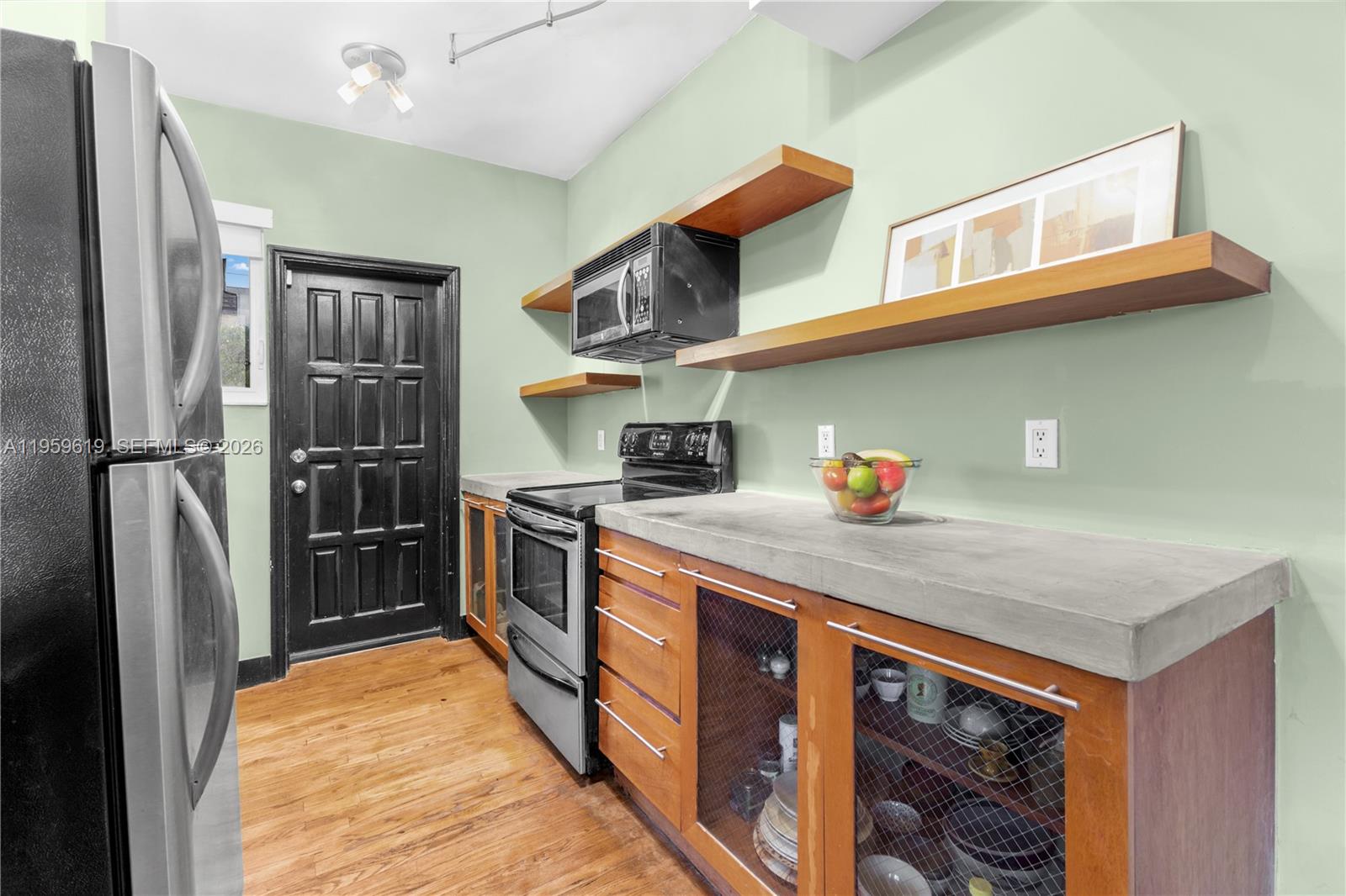 711 14th Street, Unit 4 Miami Beach, FL 33139 - Photo 12 of 27 a kitchen with stainless steel appliances granite countertop a refrigerator and a stove