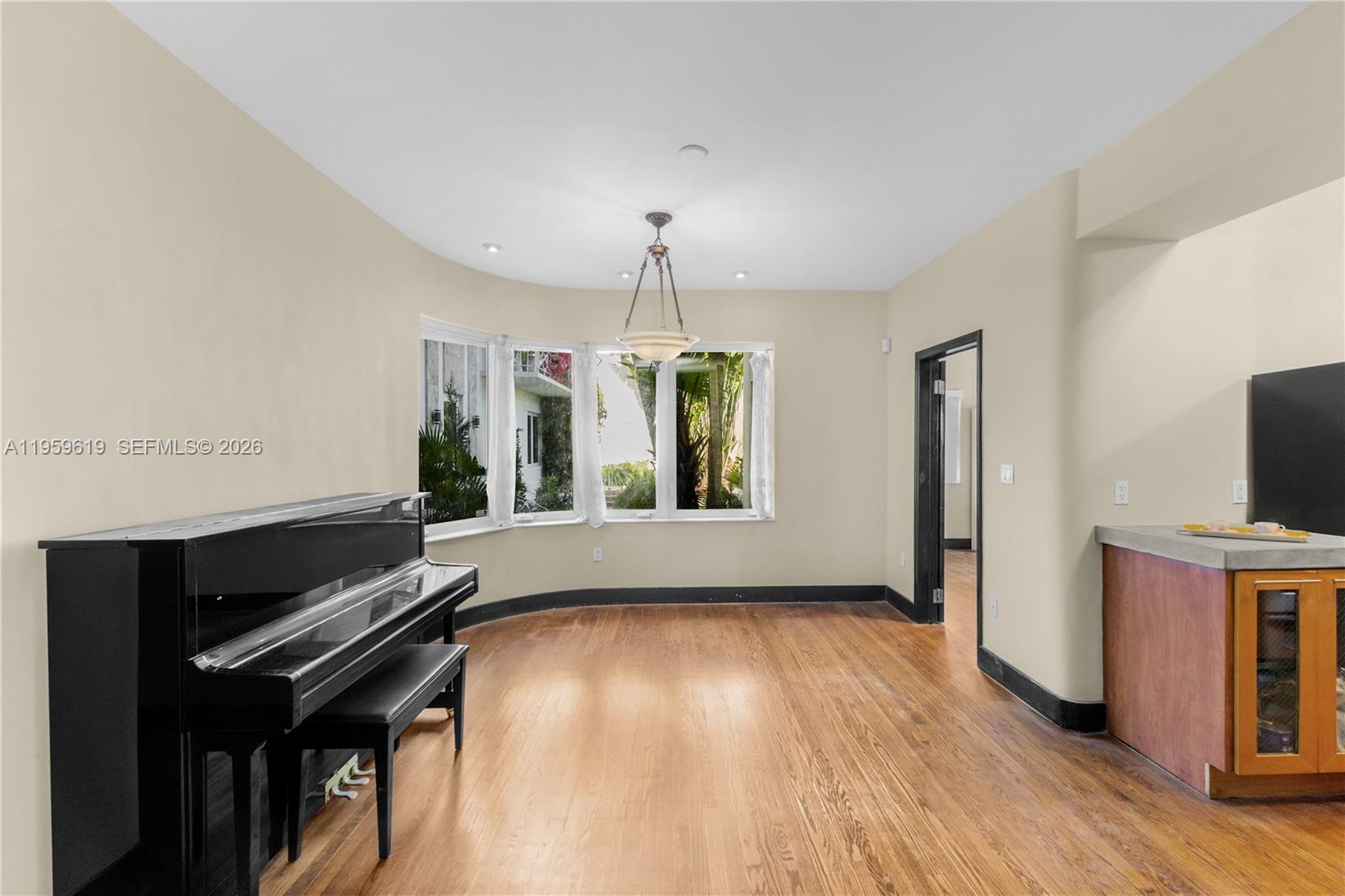711 14th Street, Unit 4 Miami Beach, FL 33139 - Photo 24 of 27 a view of an empty room with a window and wooden floor