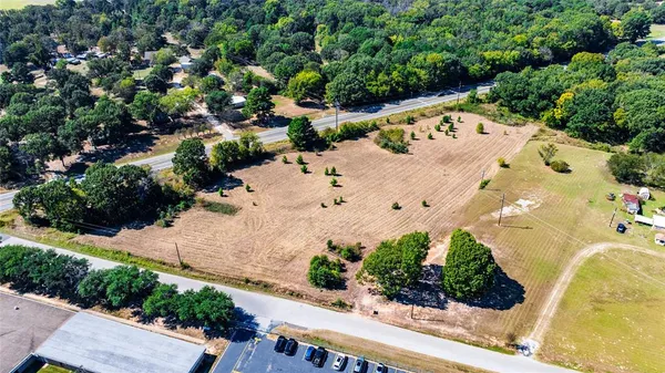 an aerial view of a house with a yard and lake view