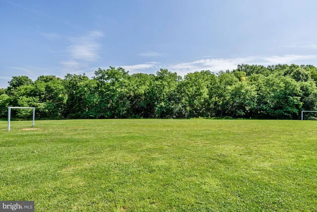 a picture of a bench in front of a wall