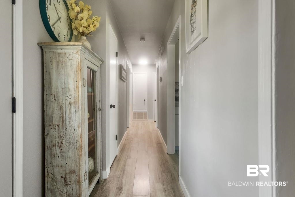 601 East Gate Circle Foley, AL 36535 - Photo 6 of 26 Hallway featuring light hardwood / wood-style floors