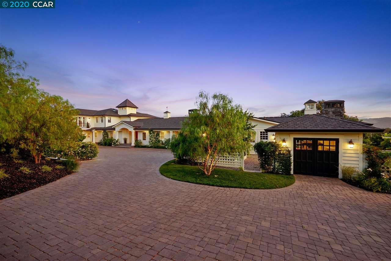 a front view of a house with a yard and a garage