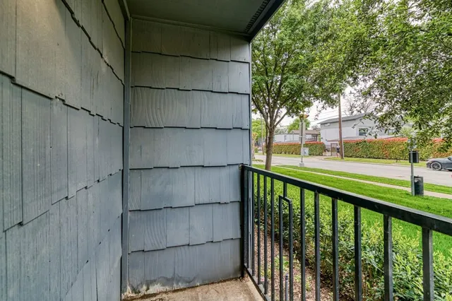 a view of a balcony with wooden fence