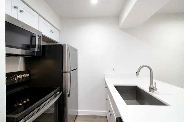 a kitchen with a sink and a refrigerator