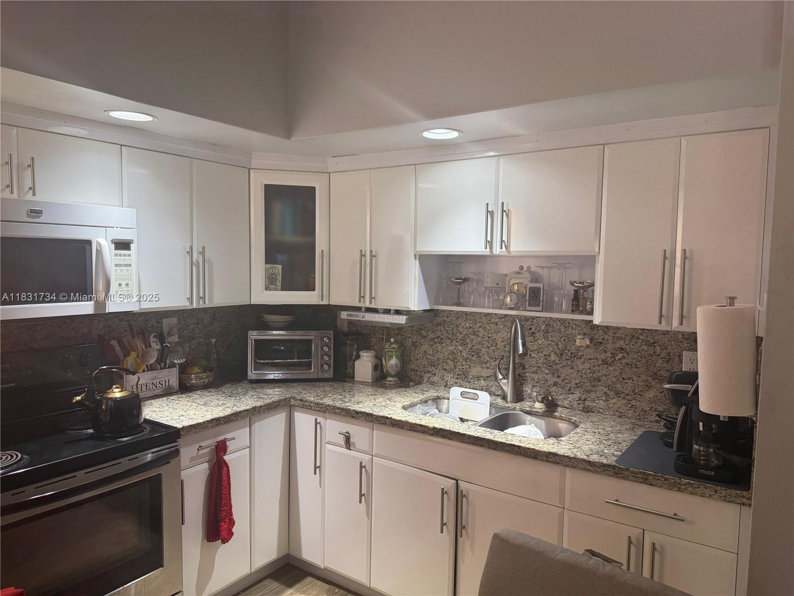 a kitchen with a sink and cabinets