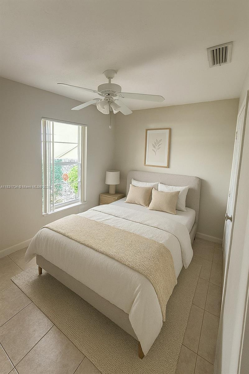 12246 Southwest 116th Lane Miami, FL 33186 - Photo 12 of 23 a bedroom with a bed and a window